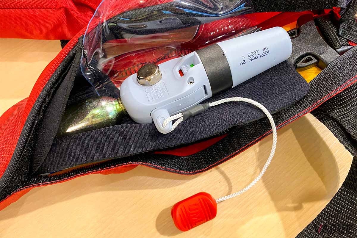 落水時に水分を感知して、ボンベから自動で気室に無害な炭酸ガスを送り込む仕組み。コードを引くことでマニュアル操作も可能となっている