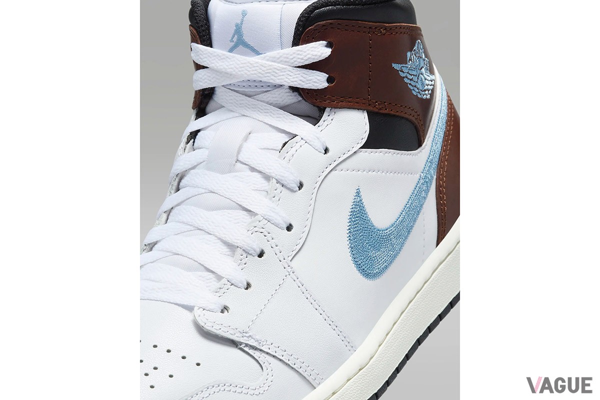 「エア ジョーダン 1 MID」の新色は、ホワイト、ブラウン、ブラックをバランスよく配置し、スウッシュとウイングロゴをライトブルーの刺しゅうで表現