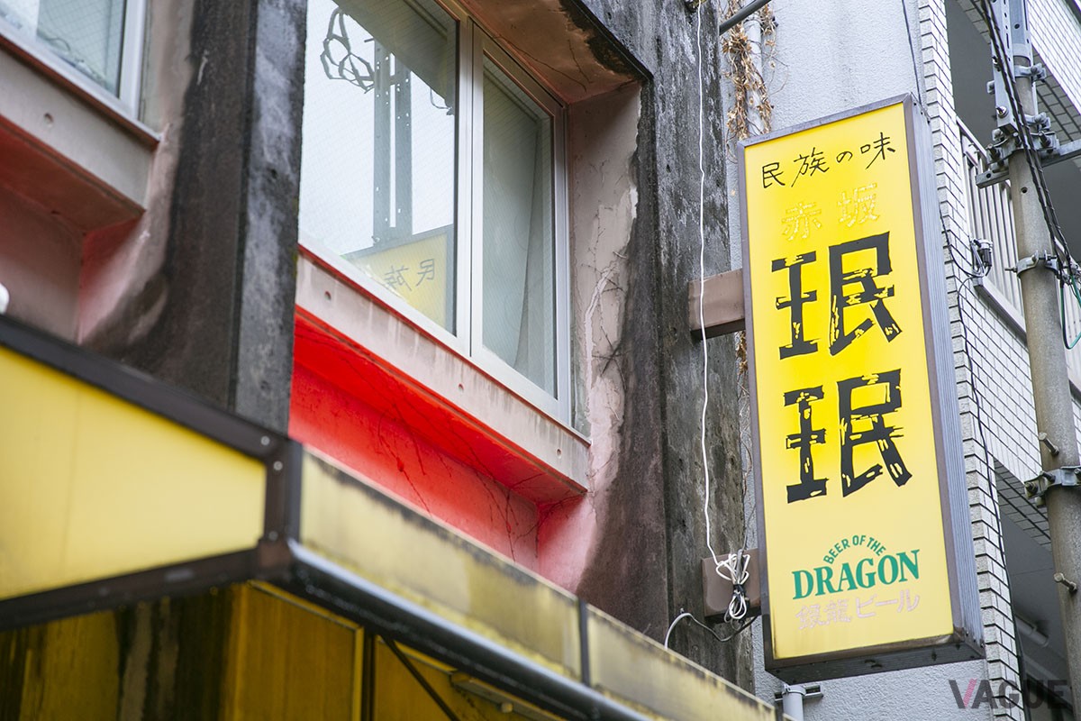 赤坂の住宅街の小道に建つ。店の歴史を感じる黄色い看板