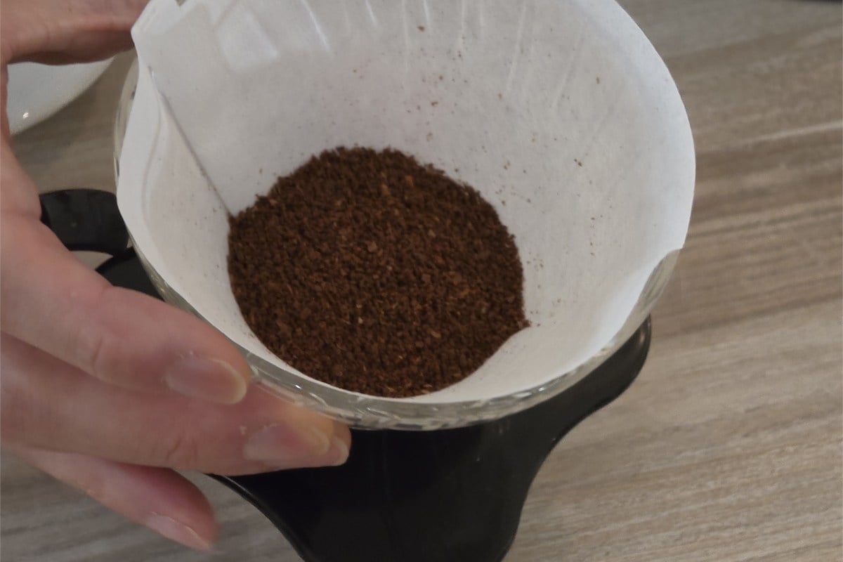 ドリッパーに入れたコーヒー粉。実演では、蒸らしのお湯を全体に行き渡らせるため、注ぐ前に粉を平らに整える手順も紹介された。注ぐ位置や量だけでなく、準備も含めて見直すことが、自宅で好みの一杯を探る手掛かりになる。