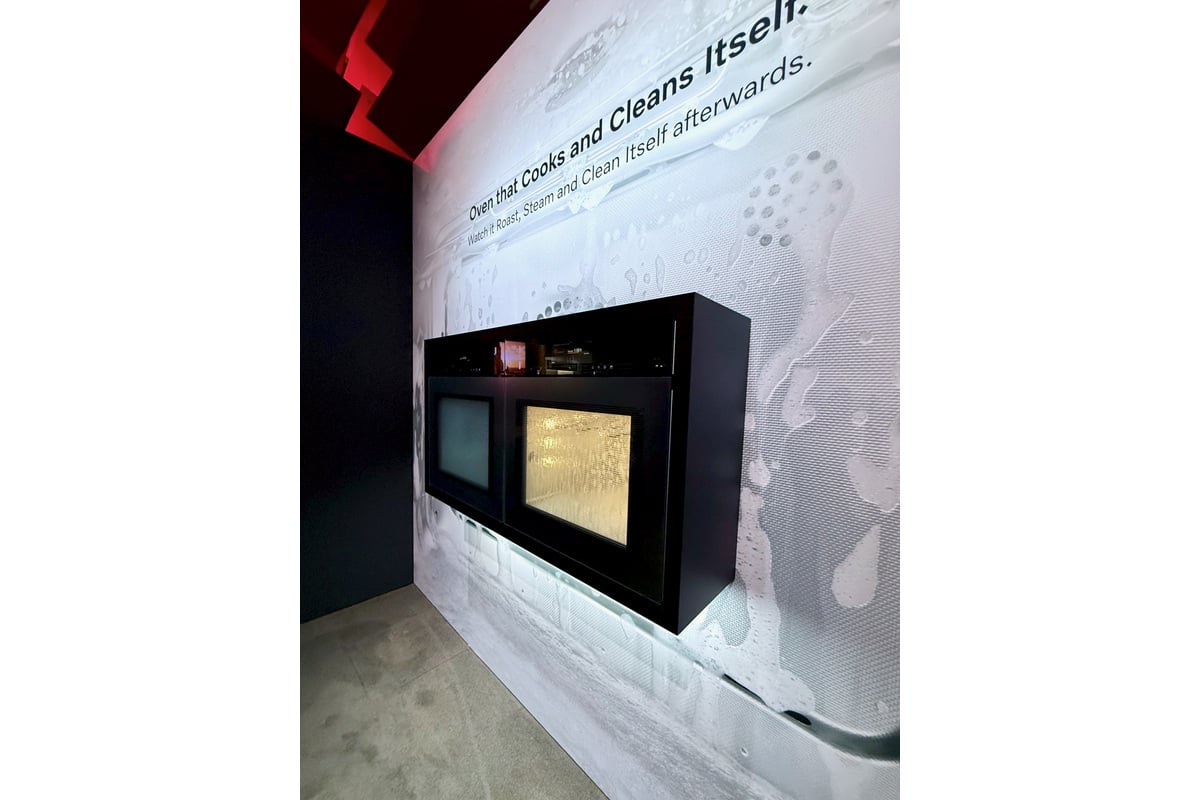 調理と庫内洗浄を紹介するオーブンの展示。壁面にも、自ら調 理し洗浄する機能を訴求するメッセージが掲げられていた。(
